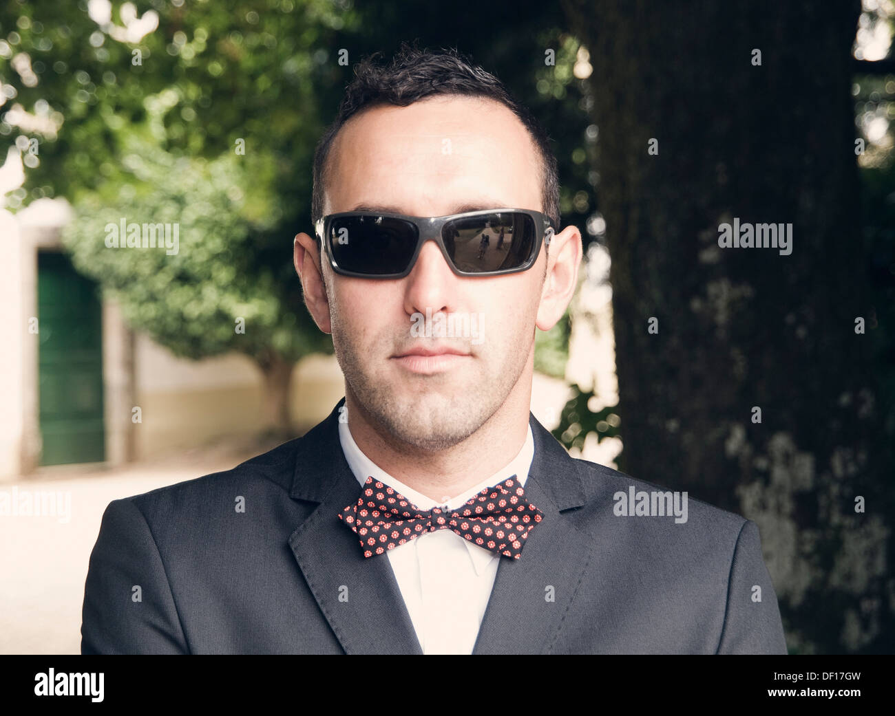 Portrait d'un homme avec papillon et lunettes de soleil en plein air Photo  Stock - Alamy