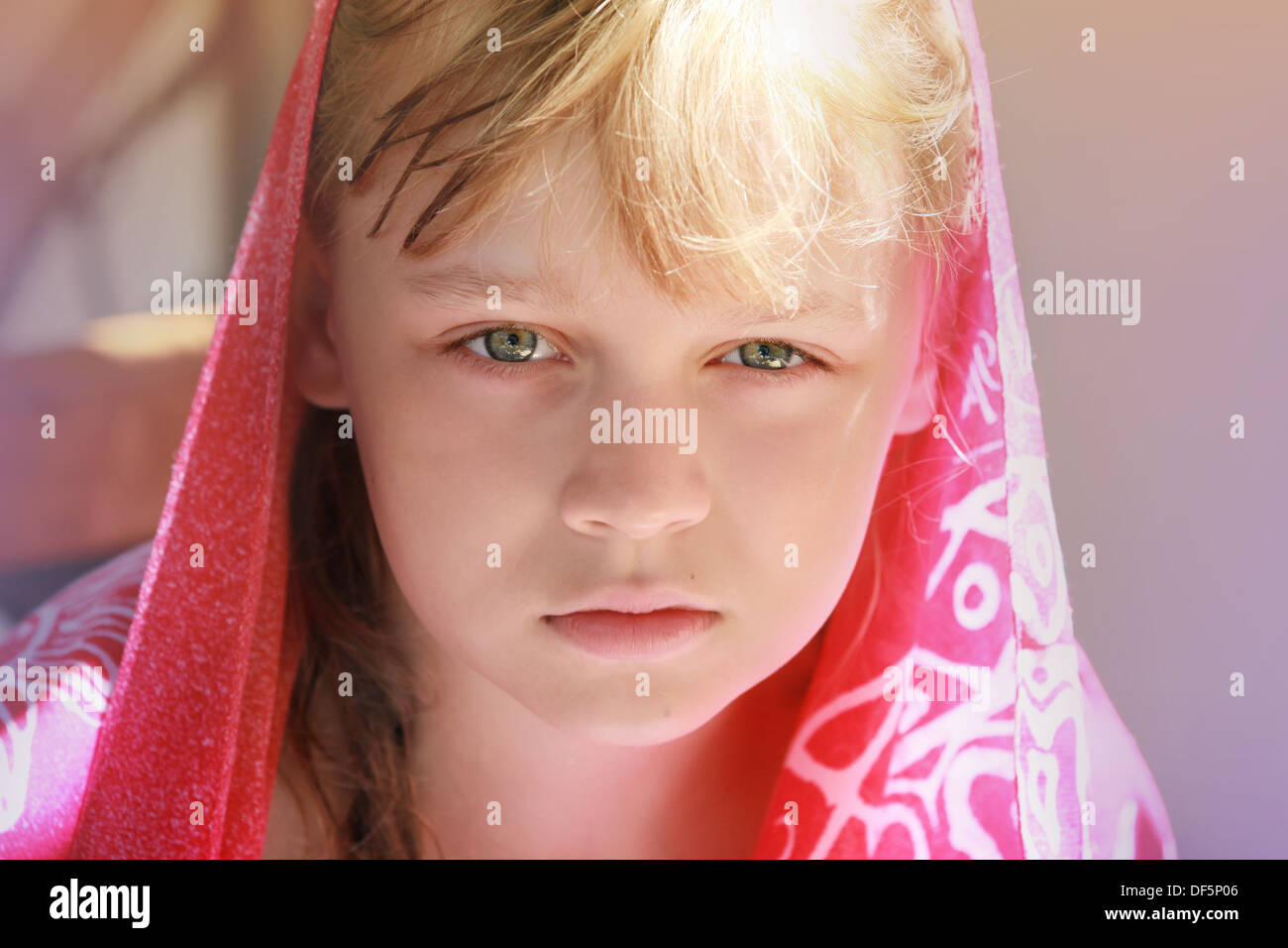 Closeup portrait of calm blonde Young little girl in red shawl Banque D'Images