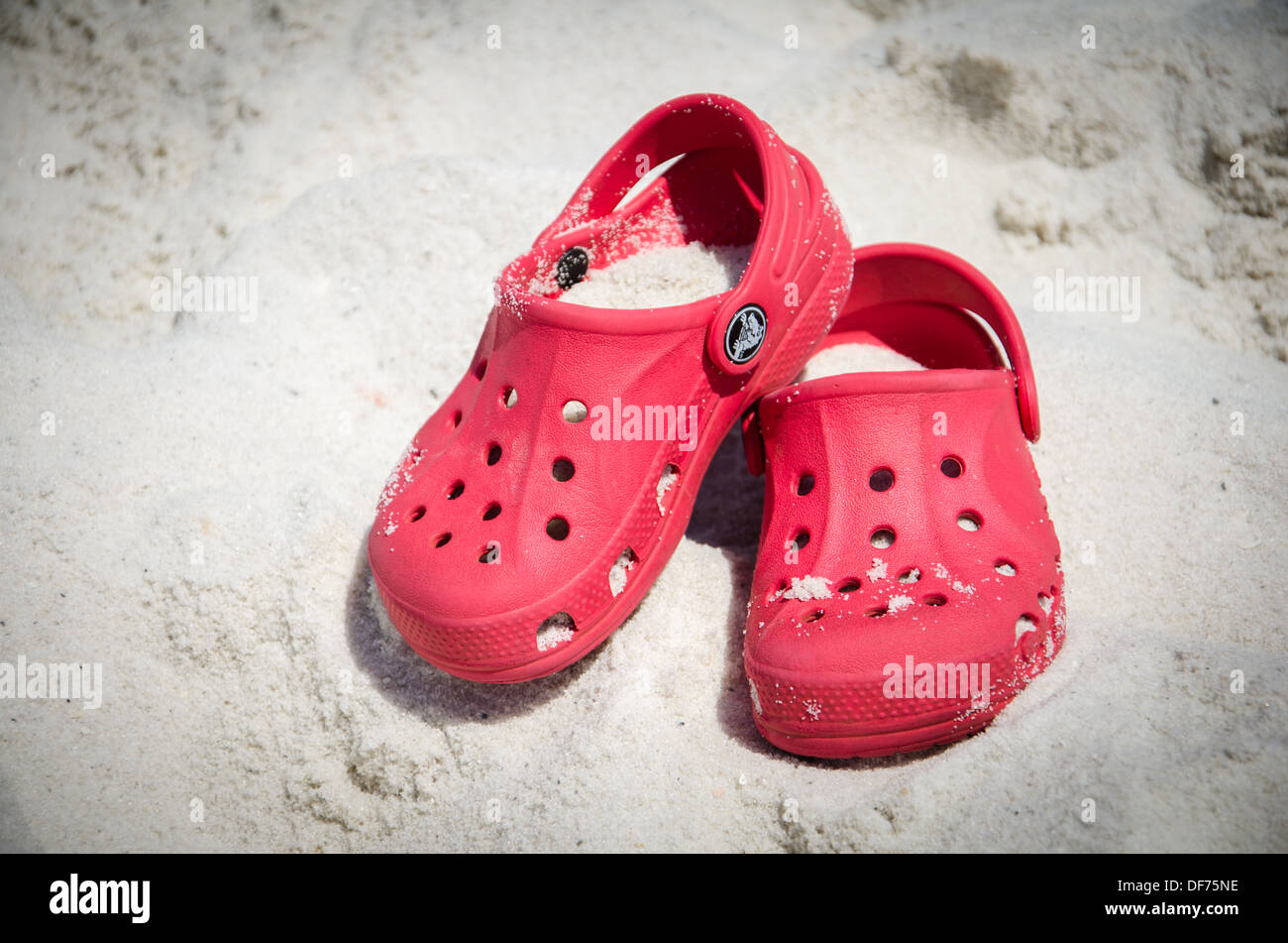 Paire de chaussures Crocs couverts de sable sur la plage Photo Stock - Alamy