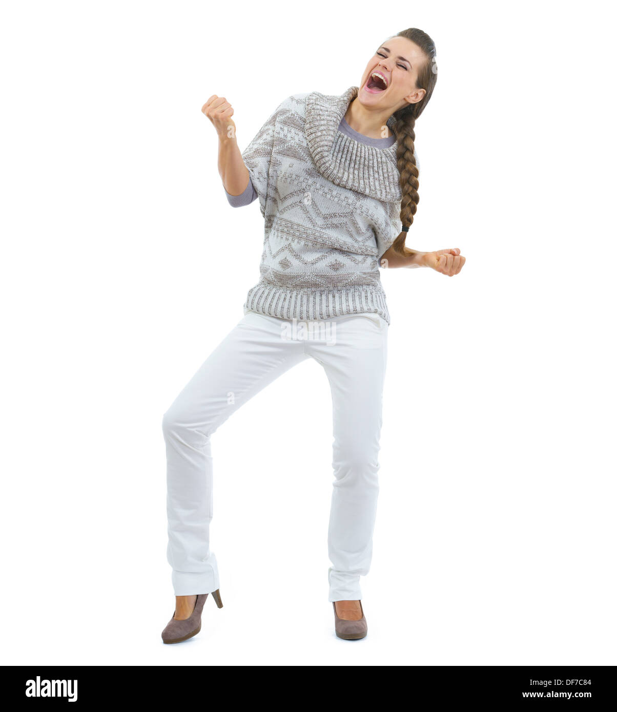 Full Length portrait of happy young woman in sweater dancing Banque D'Images