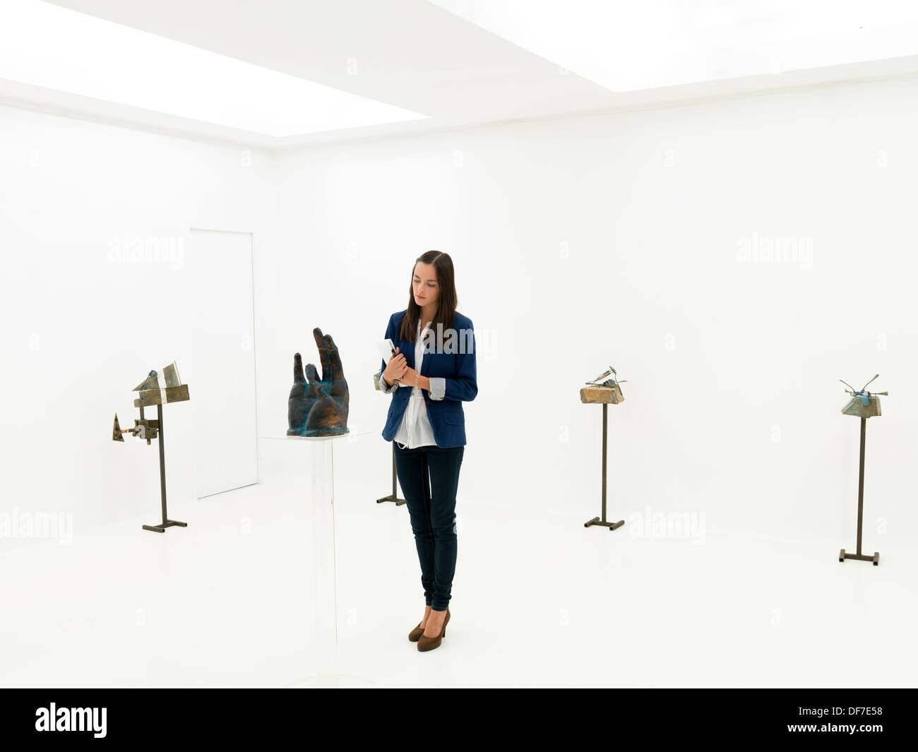 Young caucasian collectionneur d'art contemporain sculptures à afficher dans un espace d'exposition blanc Banque D'Images