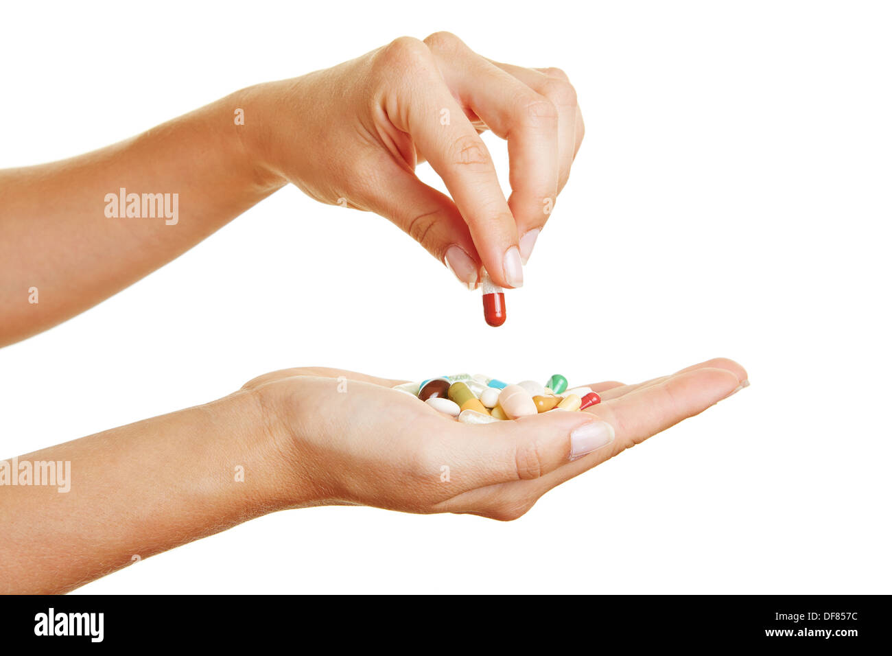 Femme main tenant une pilule rouge sur différents médicaments dans la paume de la main Banque D'Images