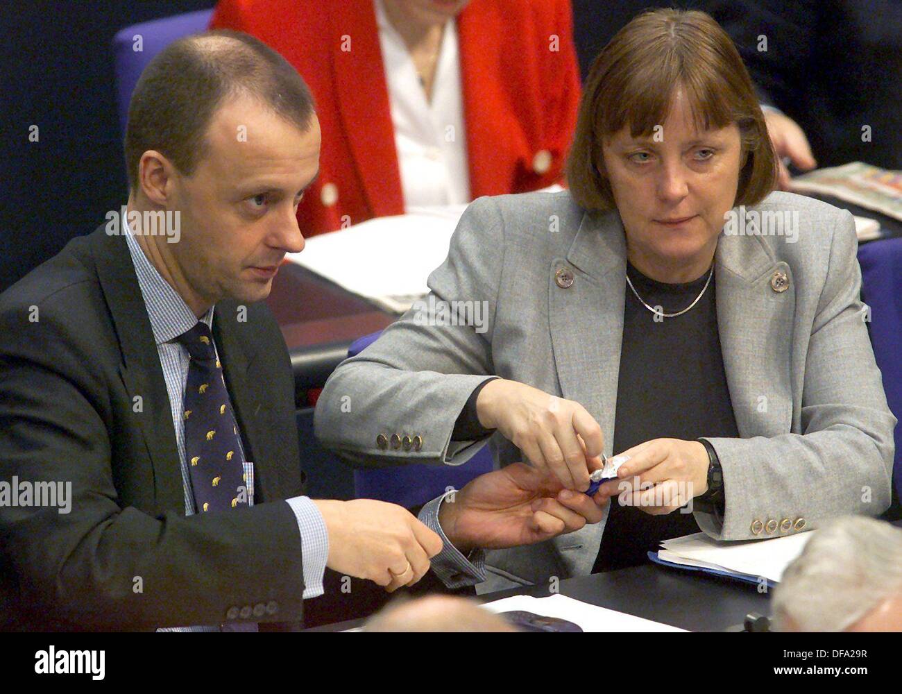Friedrich Merz et secrétaire général de la CDU, Angela Merkel partager bonbons lors d'un débat au Bundestag le 17 février en 2000. Banque D'Images