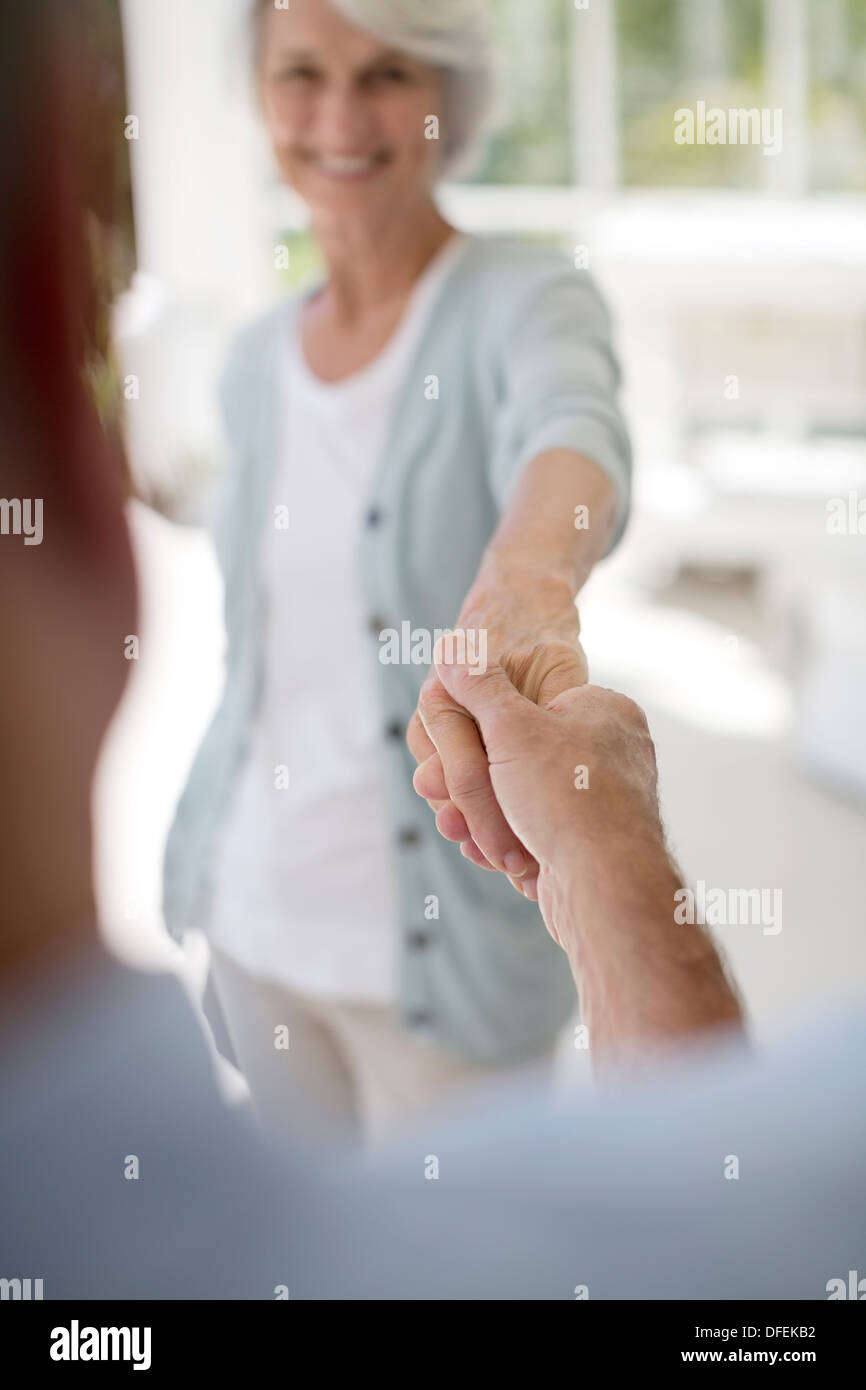 Senior couple dancing on patio Banque D'Images