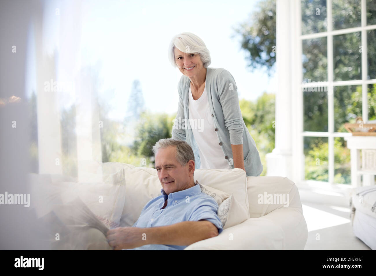 Senior couple relaxing on patio sofa Banque D'Images