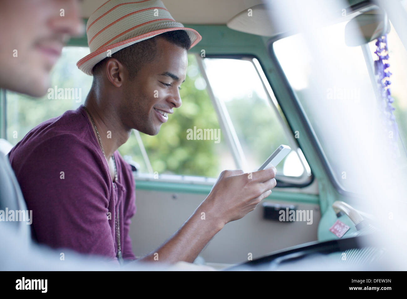 Man using cell phone in camper van Banque D'Images