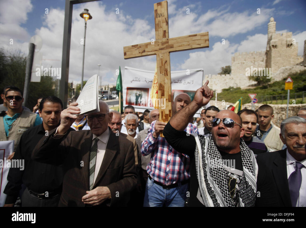 Jérusalem, Jérusalem, territoire palestinien. 6Th Oct 2013. Un manifestant palestinien est titulaire d'une croix au cours d'une manifestation contre les actes de vandalisme sur des sites chrétiens en Israël et dans les territoires occupés de Cisjordanie, à l'extérieur de la vieille ville de Jérusalem le 6 octobre 2013. La semaine dernière quatre nationalistes juifs présumés ont été arrêtés pour casser des pierres tombales dans un cimetière chrétien près de la vieille ville fortifiée de Jérusalem : Crédit Saeed Qaq/APA Images/ZUMAPRESS.com/Alamy Live News Banque D'Images