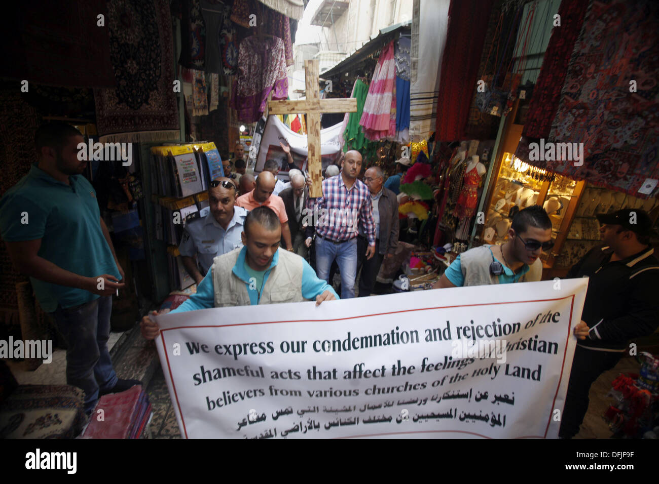 Jérusalem, Jérusalem, territoire palestinien. 6Th Oct 2013. Un manifestant palestinien est titulaire d'une croix au cours d'une manifestation contre les actes de vandalisme sur des sites chrétiens en Israël et dans les territoires occupés de Cisjordanie, à l'extérieur de la vieille ville de Jérusalem le 6 octobre 2013. La semaine dernière quatre nationalistes juifs présumés ont été arrêtés pour casser des pierres tombales dans un cimetière chrétien près de la vieille ville fortifiée de Jérusalem : Crédit Saeed Qaq/APA Images/ZUMAPRESS.com/Alamy Live News Banque D'Images