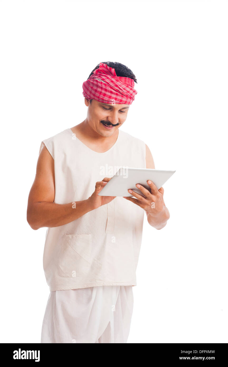 Farmer using a digital tablet and smiling Banque D'Images