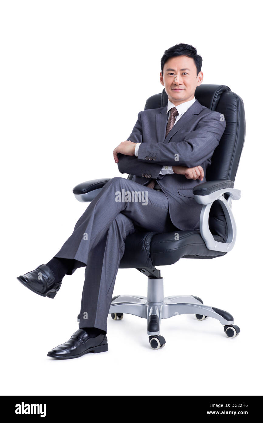 Gestionnaire maturité sitting in chair Banque D'Images