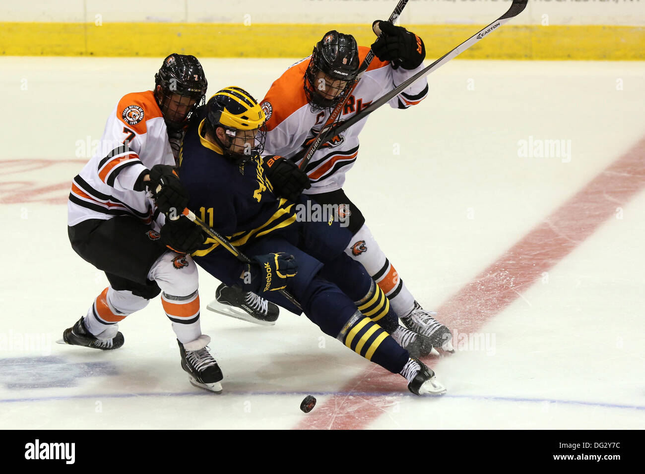 Rochester, New York, USA. 12 octobre, 2013. RIT's Brad McGowan (7) et Matt Garbowsky (9) rejoint Michigan's Zach Hyman (11) au cours de la première période. Michigan défait RIT 7-4 à Blue Cross Arena à Rochester, New York le 12 octobre, 2013 © Nick Serrata/Eclipse/ZUMAPRESS.com/Alamy Live News Banque D'Images