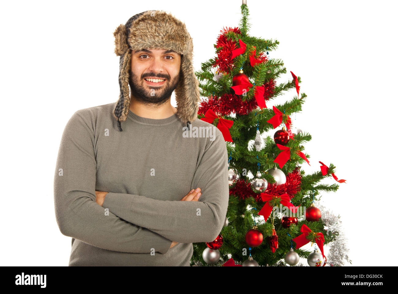 Heureux hiver homme with fur hat in front of Christmas Tree Banque D'Images