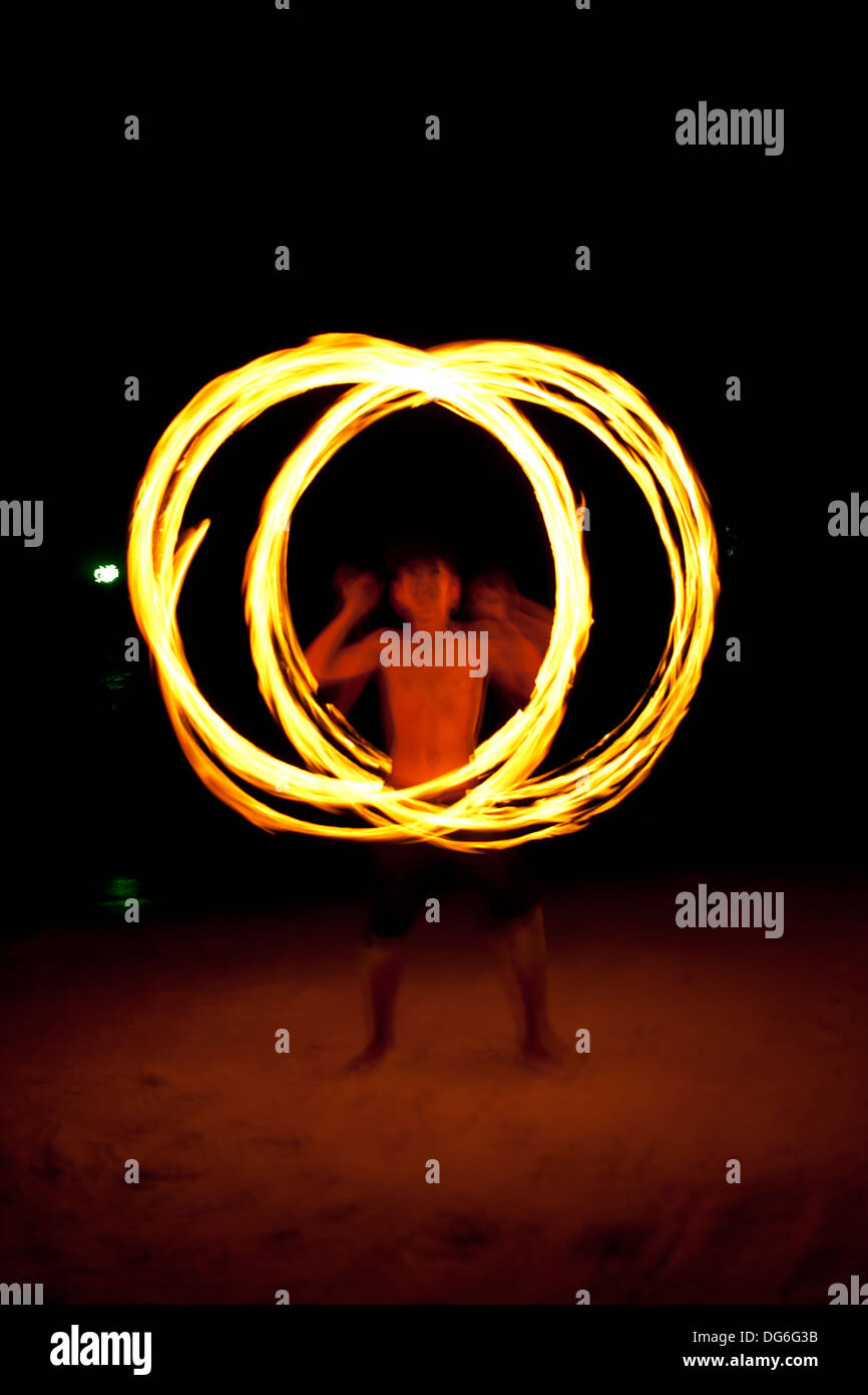 Danse du feu, homme tenue twirling dance sur l'île Banque D'Images
