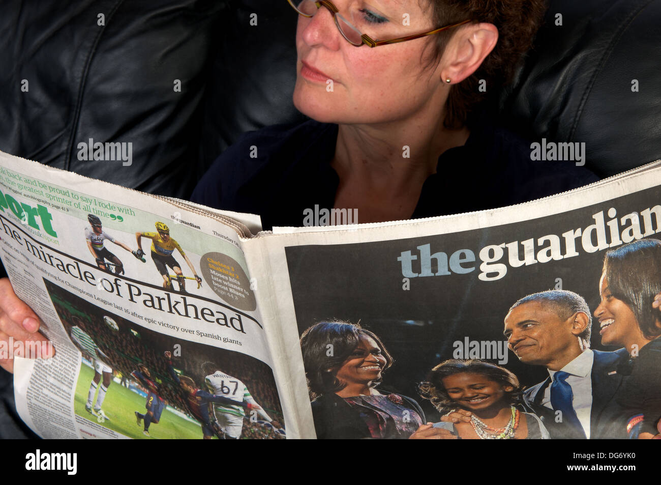 Femme lisant un exemplaire du Guardian (08.11.12) Banque D'Images