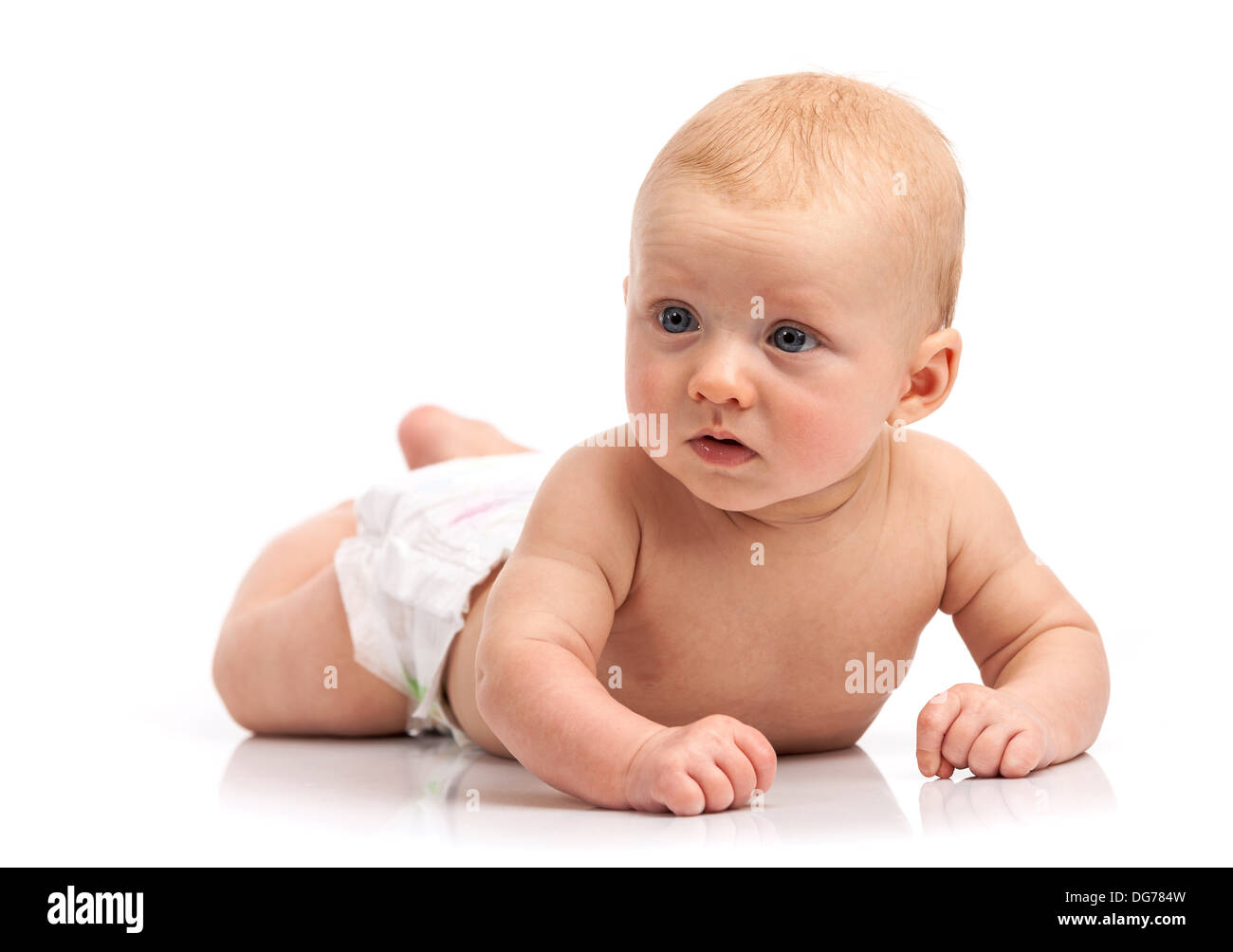 Cute baby boy lying on stomach over white background Banque D'Images