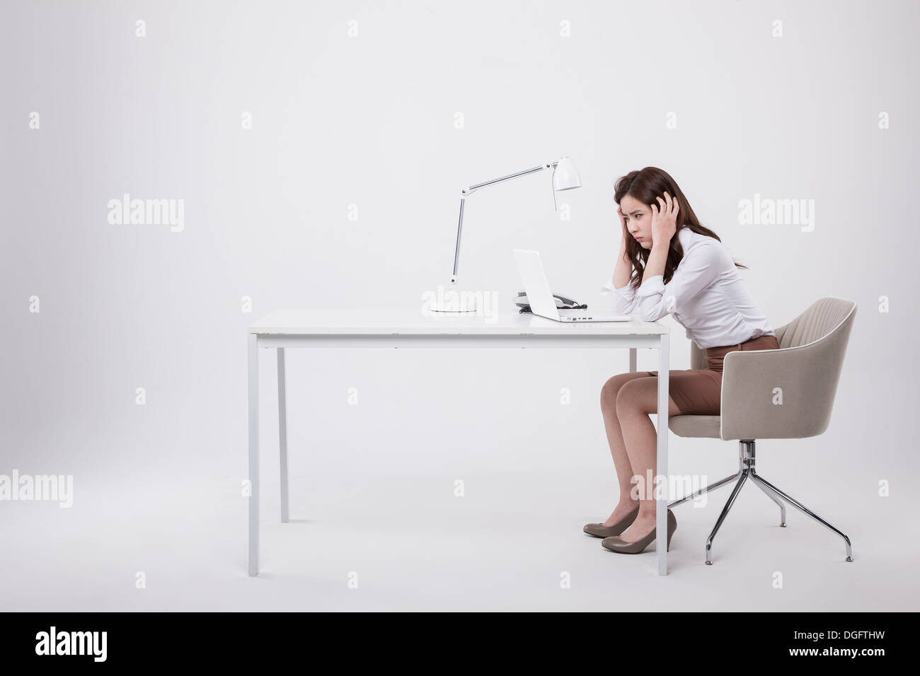 Une business woman sitting at desk Banque D'Images