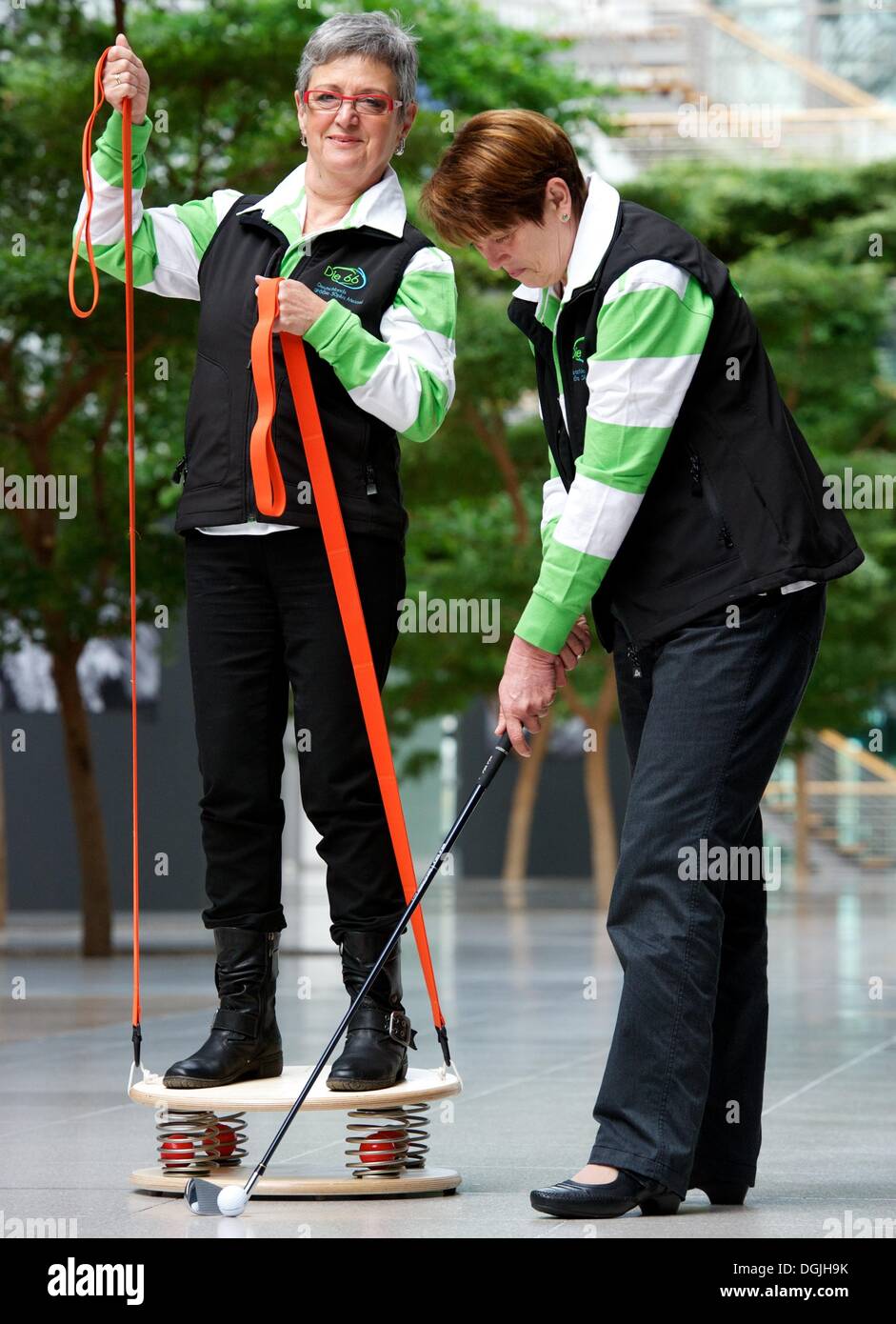Leipzig, Allemagne. 22 octobre, 2013. Stadach Birgitt aînés (L) et l'équilibrage de l'essai d'hiver Sonja devive Vestimed Holz-Hoerz par GmbH et l'ensemble de golf par Golf GmbH à pied au centre des congrès de Leipzig, Allemagne, 22 octobre 2013. L'expo 'Die 66' (lit. Le 66) En vedette Produits et tendances pour les personnes de plus de 50 ans et est ouvert du 25 au 27 octobre 2013. Photo : PETER ENDIG/dpa/Alamy Live News Banque D'Images