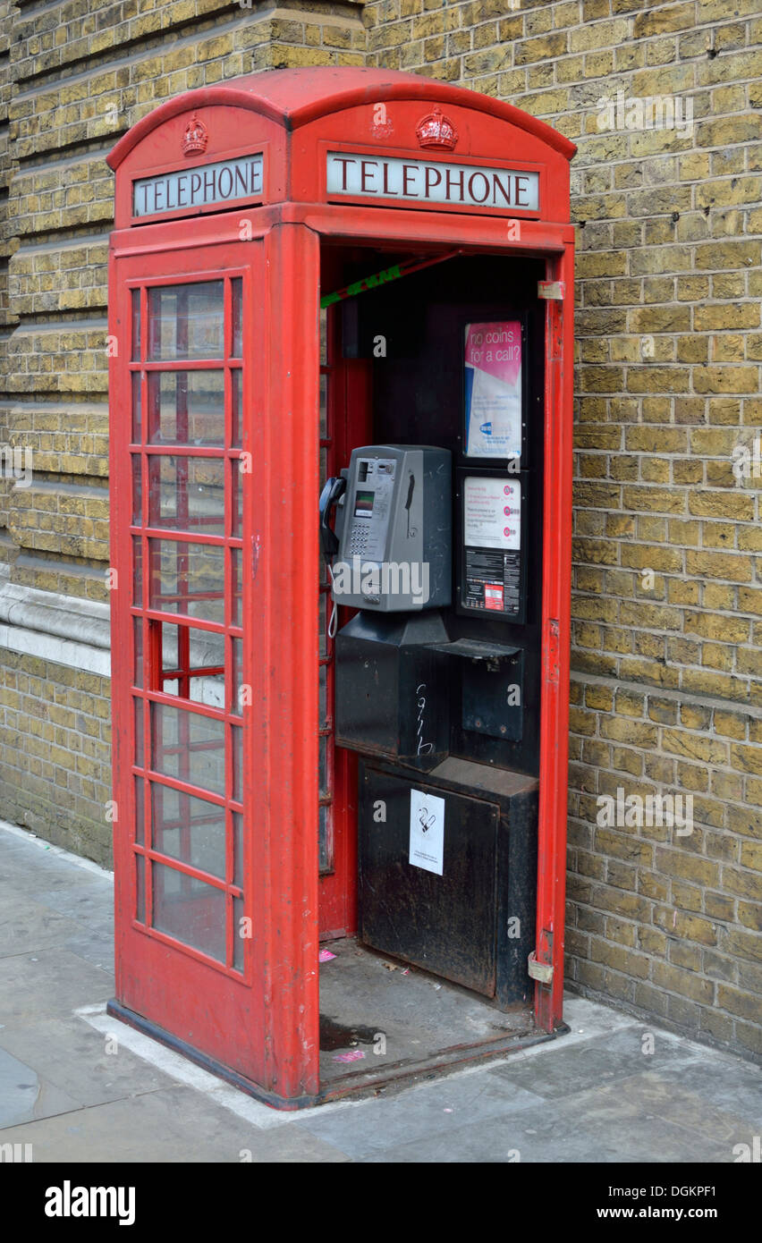 Une boîte de téléphone rouge emblématique avec une porte manquante. Banque D'Images