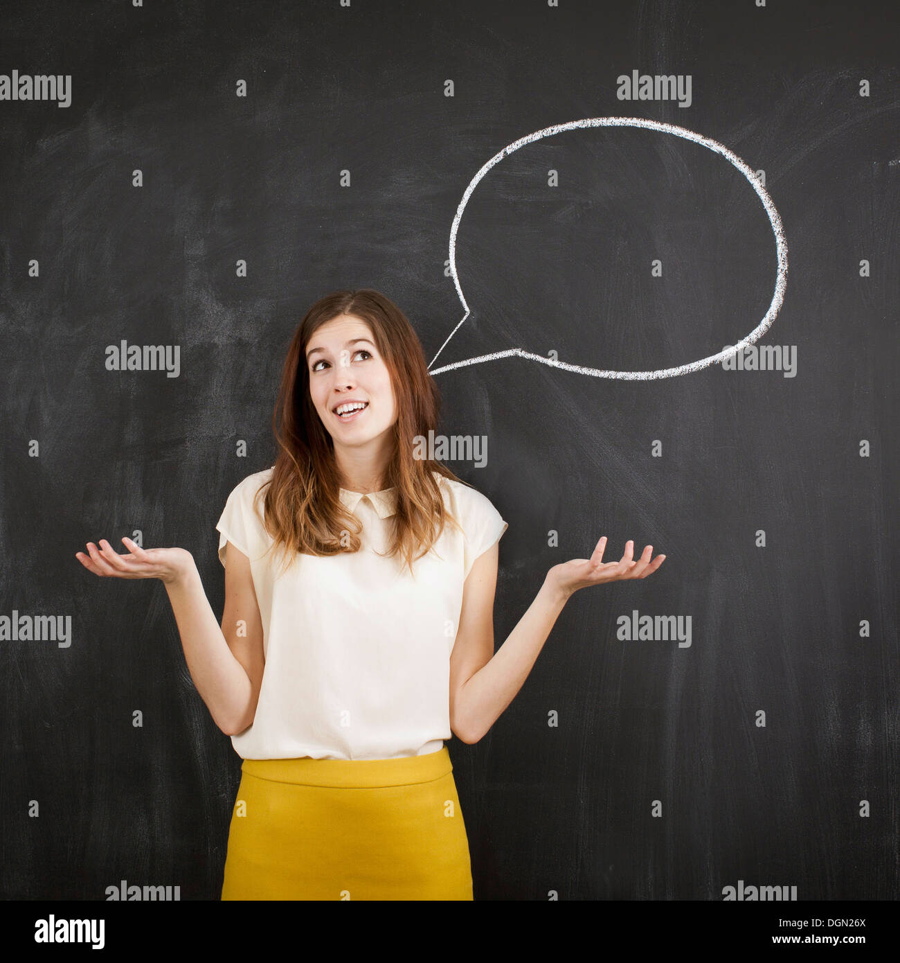Studio portrait of woman with chalk speech bubble Banque D'Images