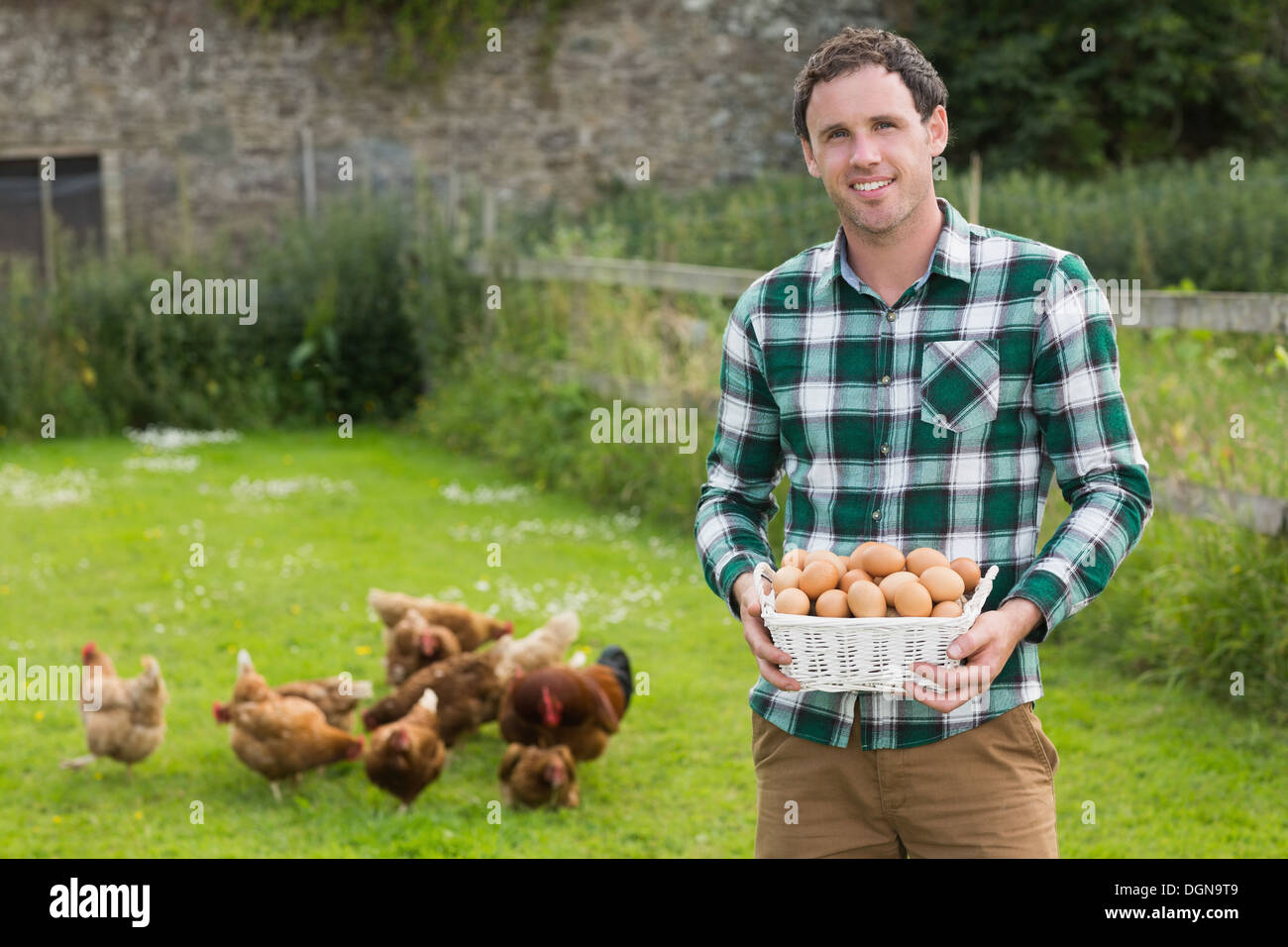 Fier Jeune homme tenant un panier rempli d'oeufs Banque D'Images