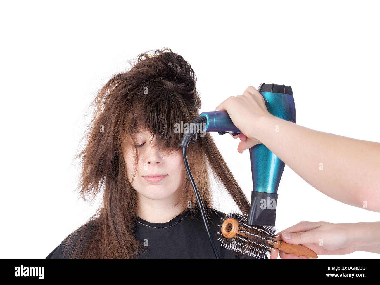 Woman having her hair blow séché, isolated on white Banque D'Images