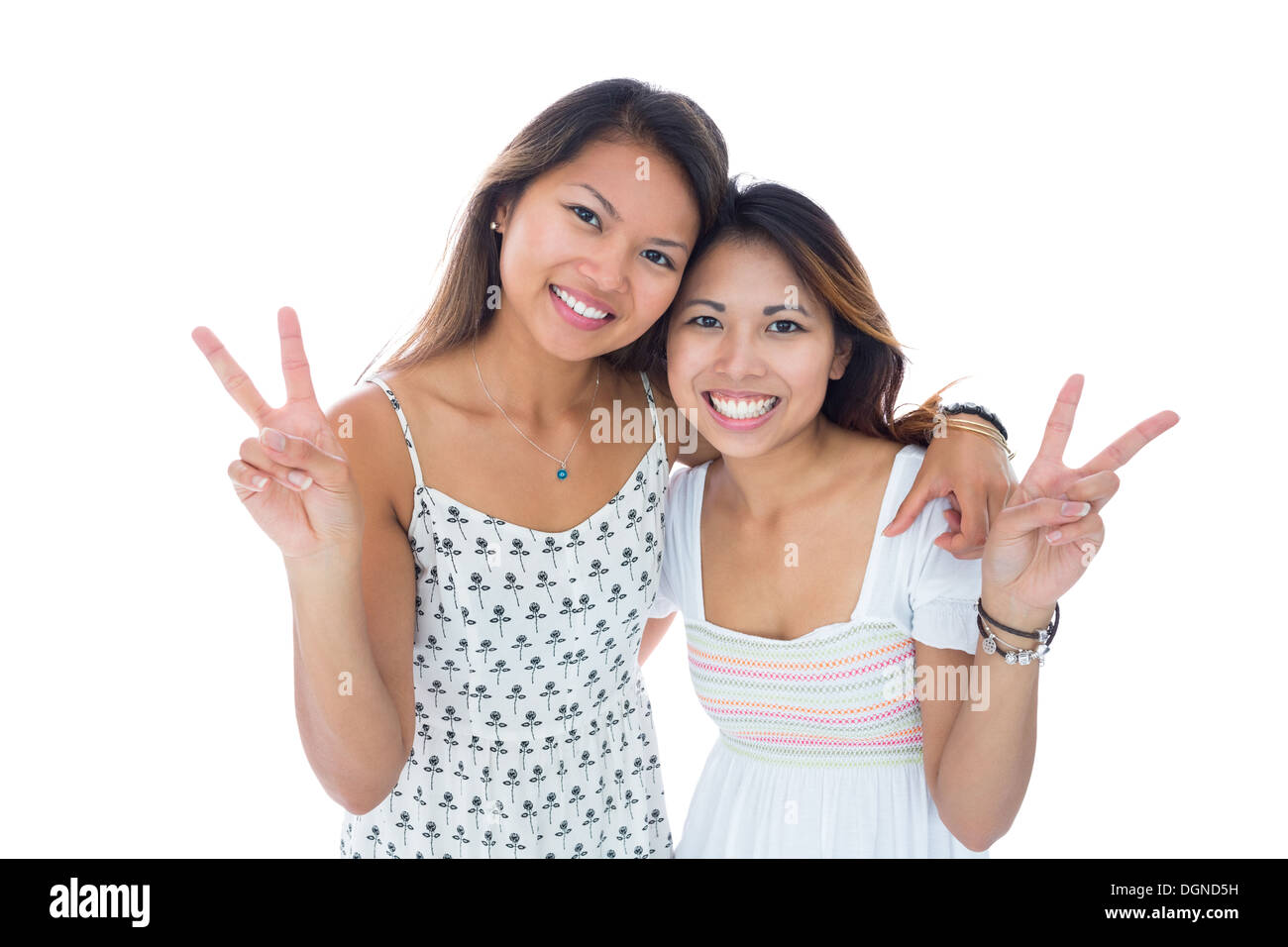 Deux jeunes femmes sourire faisant un geste de paix Banque D'Images