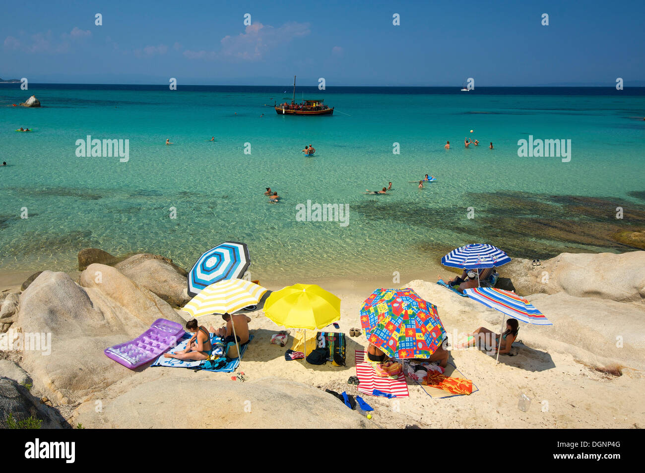 Les touristes avec des parasols à la plage de Portokali, Kavourotypes, Sithonia, Halkidiki ou Halkidiki, Grèce, Europe Banque D'Images
