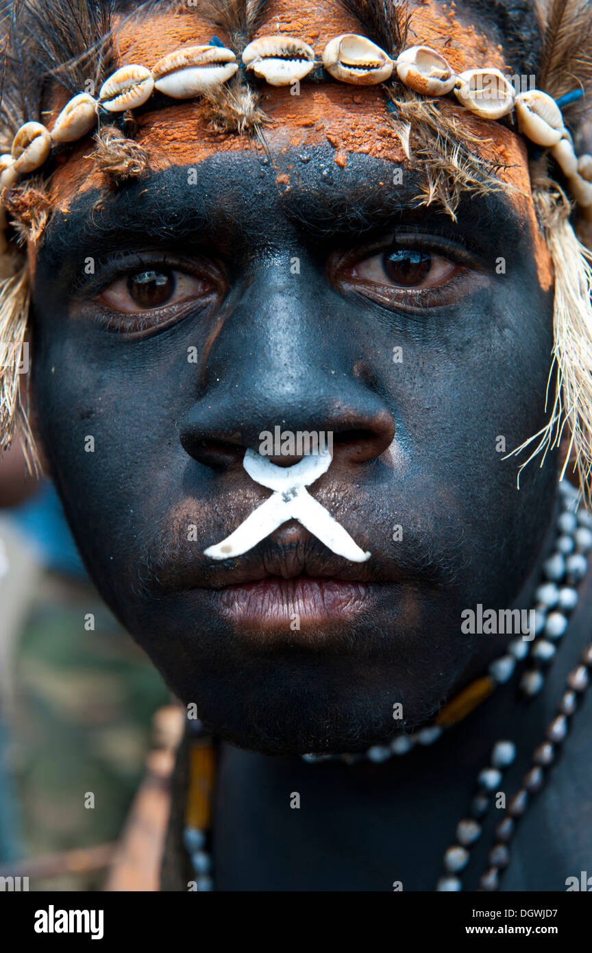 L'homme noir peint et décoré au cours du traditionnel chanter chanter dans les highlands, Enga, Highlands, Papouasie Nouvelle Guinée Banque D'Images