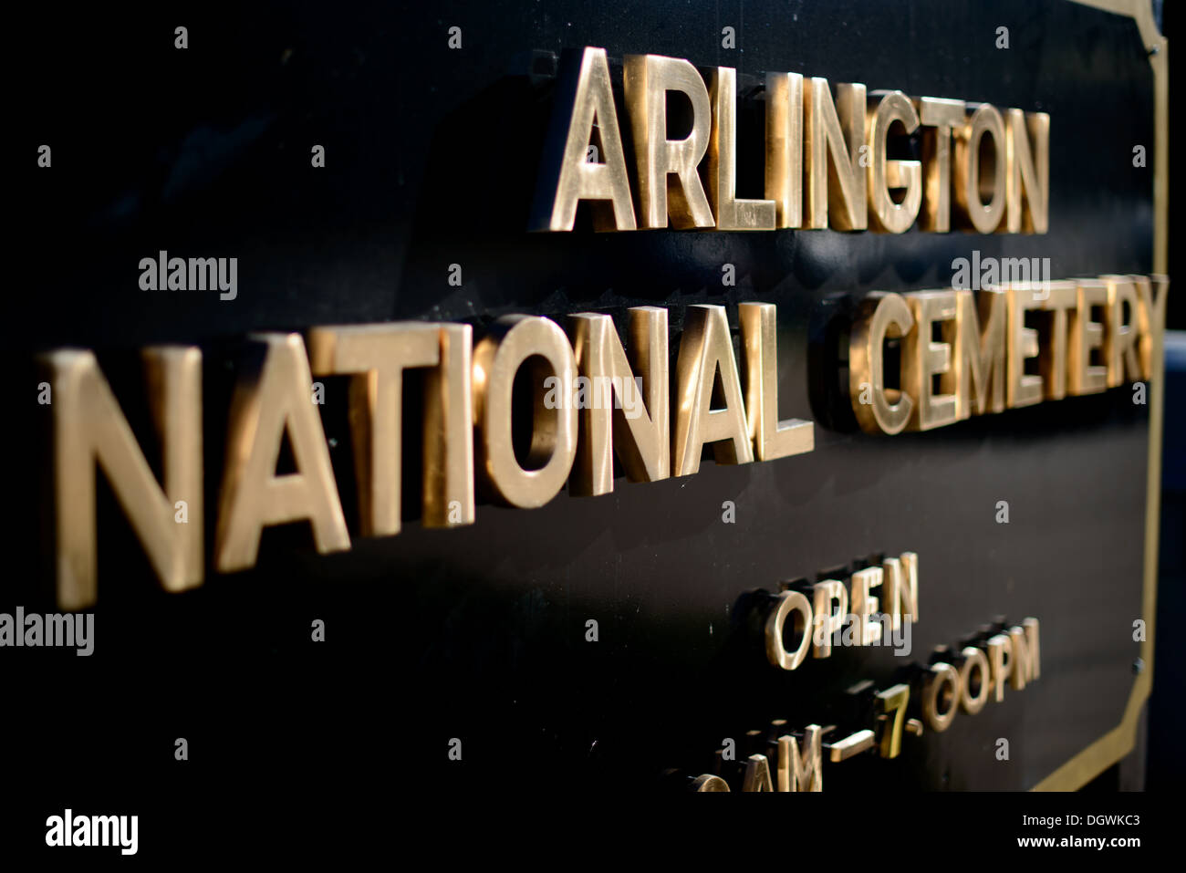 Panneau d'entrée du cimetière national d'Arlington Arlington Virginie // ARLINGTON, Virginie, États-Unis — le panneau noir et or frappant marquant l'entrée du cimetière national d'Arlington est une porte d'entrée solennelle vers le terrain le plus sacré d'Amérique. Ce marqueur emblématique accueille les visiteurs sur le lieu de repos final de centaines de milliers d'anciens combattants militaires, servant de rappel poignant des sacrifices consentis au service de la nation. Banque D'Images