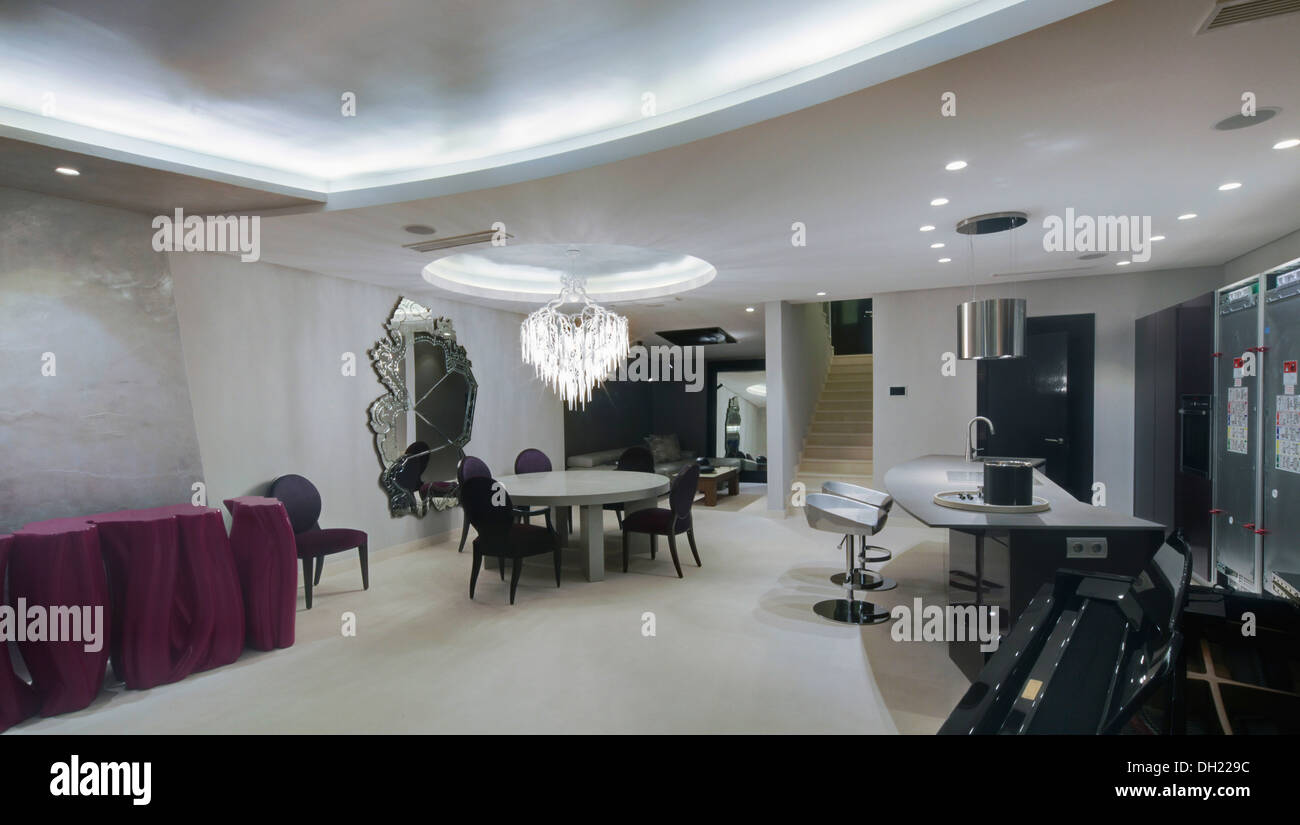 L'éclairage sur faux plafond dans un coin repas à plan ouvert appartement espagnol avec rose lumineux table console Banque D'Images