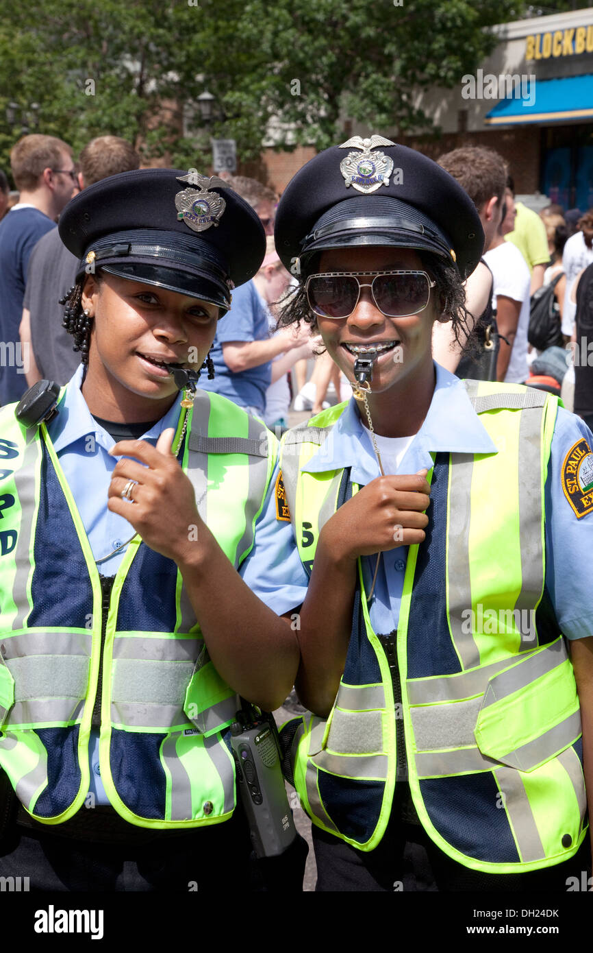 Deux femmes de la police noir heureux de diriger la circulation avec des sifflets à Grand Old Day Festival St Paul Minnesota MN USA Banque D'Images