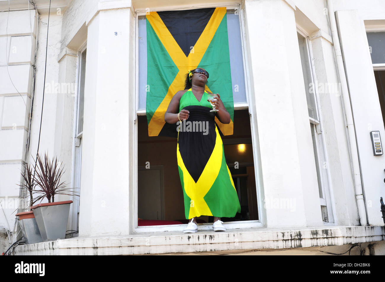 Une femme portant un drapeau jamaïcain à la robe carnaval de Notting Hill, Londres Banque D'Images