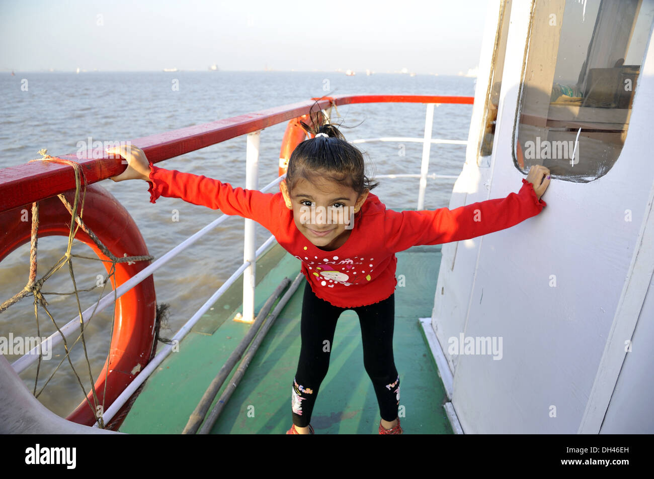 Fille jouant sur le bateau en mer MR# 736L Banque D'Images