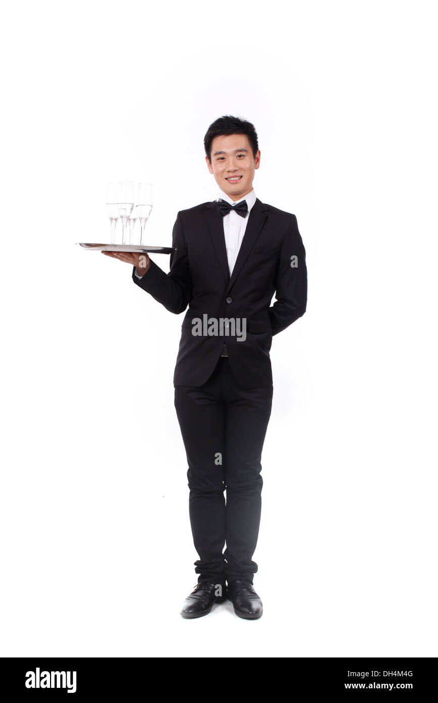Man in tuxedo holding a plate Banque D'Images