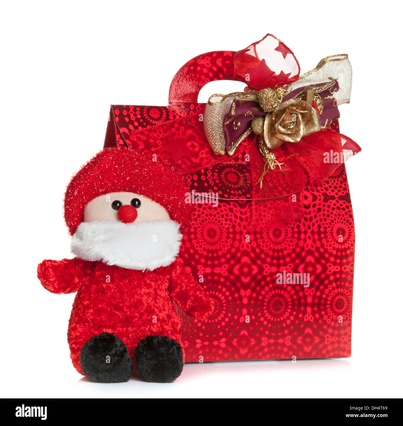 Sac rouge cadeaux avec le père noël puppet isolé sur fond blanc. Banque D'Images