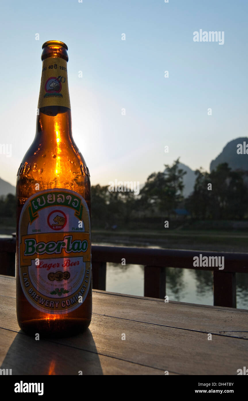 Close up vertical d'une bouteille de bière Beerlao original au coucher du soleil. Banque D'Images