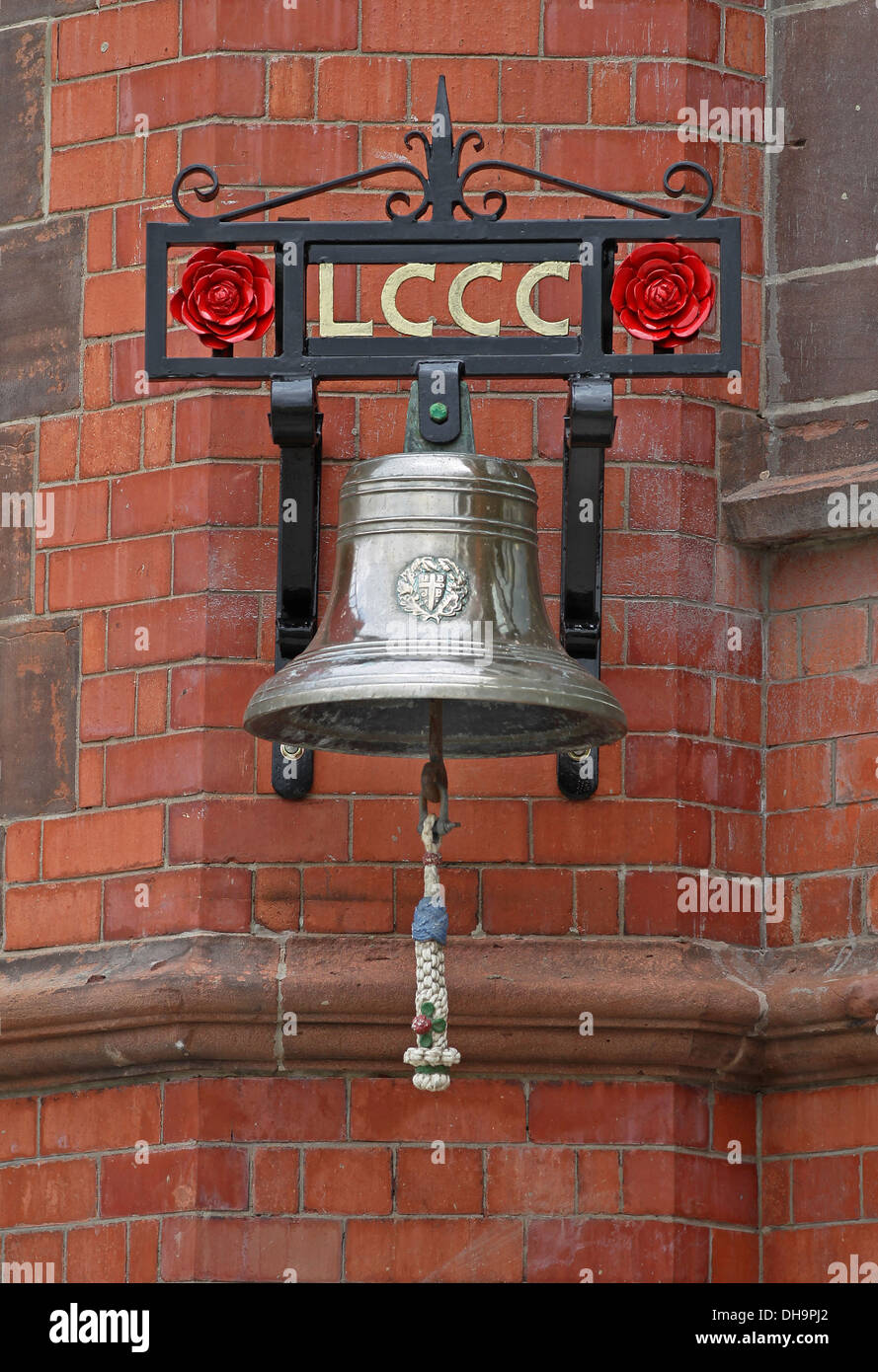 La cloche avec le Lancashire rose rouge sur le mur de brique rouge du pavillon à Unis Old Trafford Cricket Ground Banque D'Images