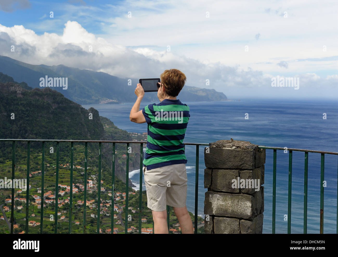 Madère au Portugal. Un touriste en utilisant un ipad tablet appareil pour prendre une photo de l'île scenery Banque D'Images