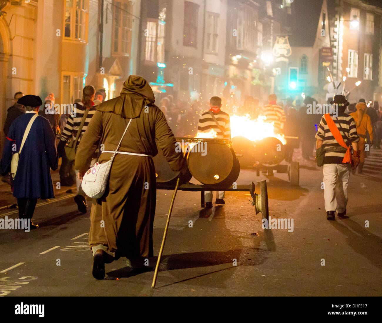 Un moine trails l'incendie de la batterie à la fin de la procession de la rue South Bonfire Society à Lewes Bonfire Night 2013 Banque D'Images