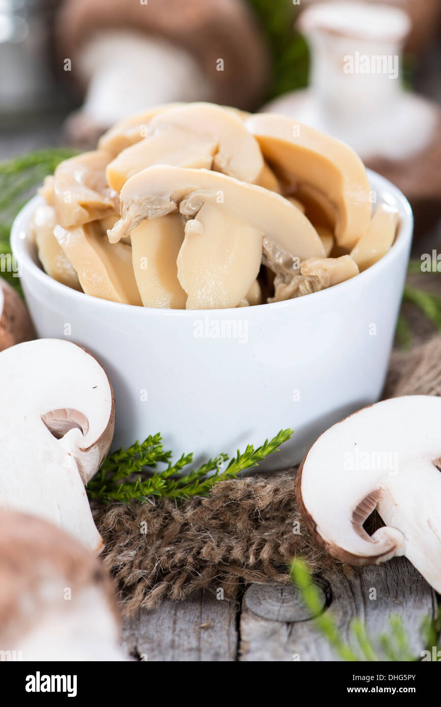 Partie de champignons en conserve sur fond de bois Banque D'Images
