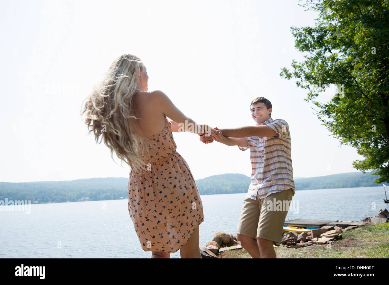 Young couple holding hands by lake Banque D'Images