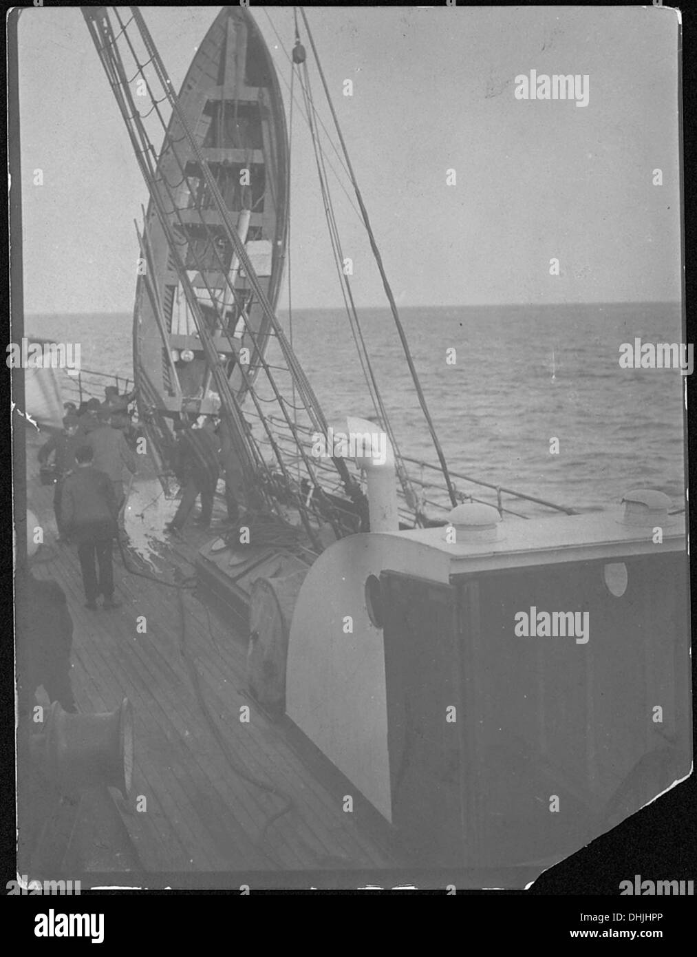 Une photographie sans sous-titrage représentant probablement un canot de sauvetage Titanic hissé pour drainer l'eau, reflétant les efforts de récupération après la catastrophe après le naufrage du RMS Titanic en 1912. Banque D'Images
