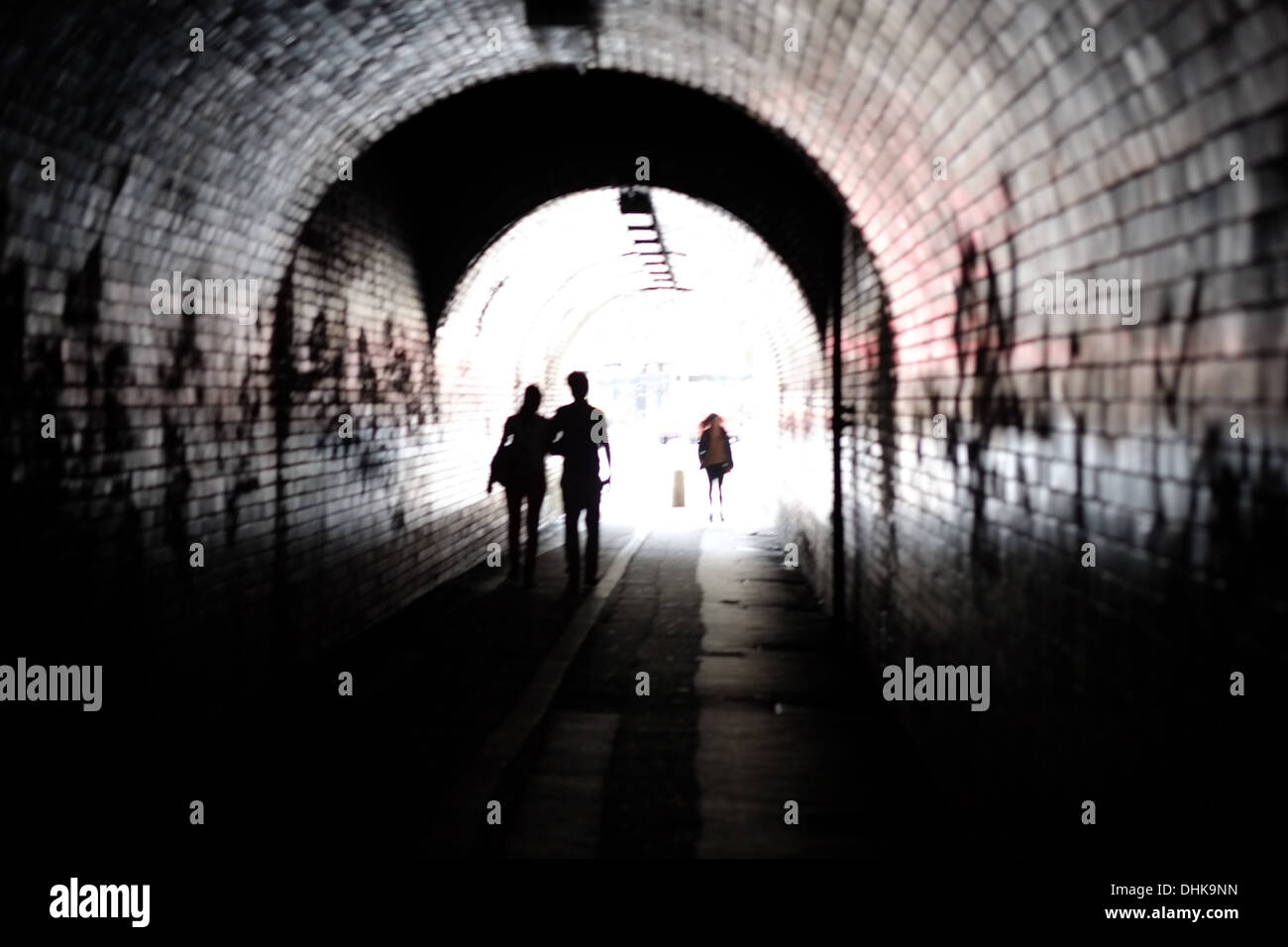Un tunnel ferroviaire en briques avec des gens qui marchent à travers elle méconnaissable, tourné dans un style artistique Banque D'Images