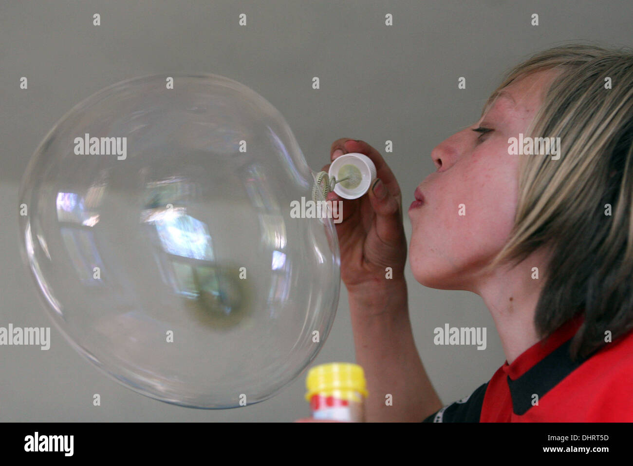 Jeune garçon soufflant de bulles, souffleur de bulles Banque D'Images