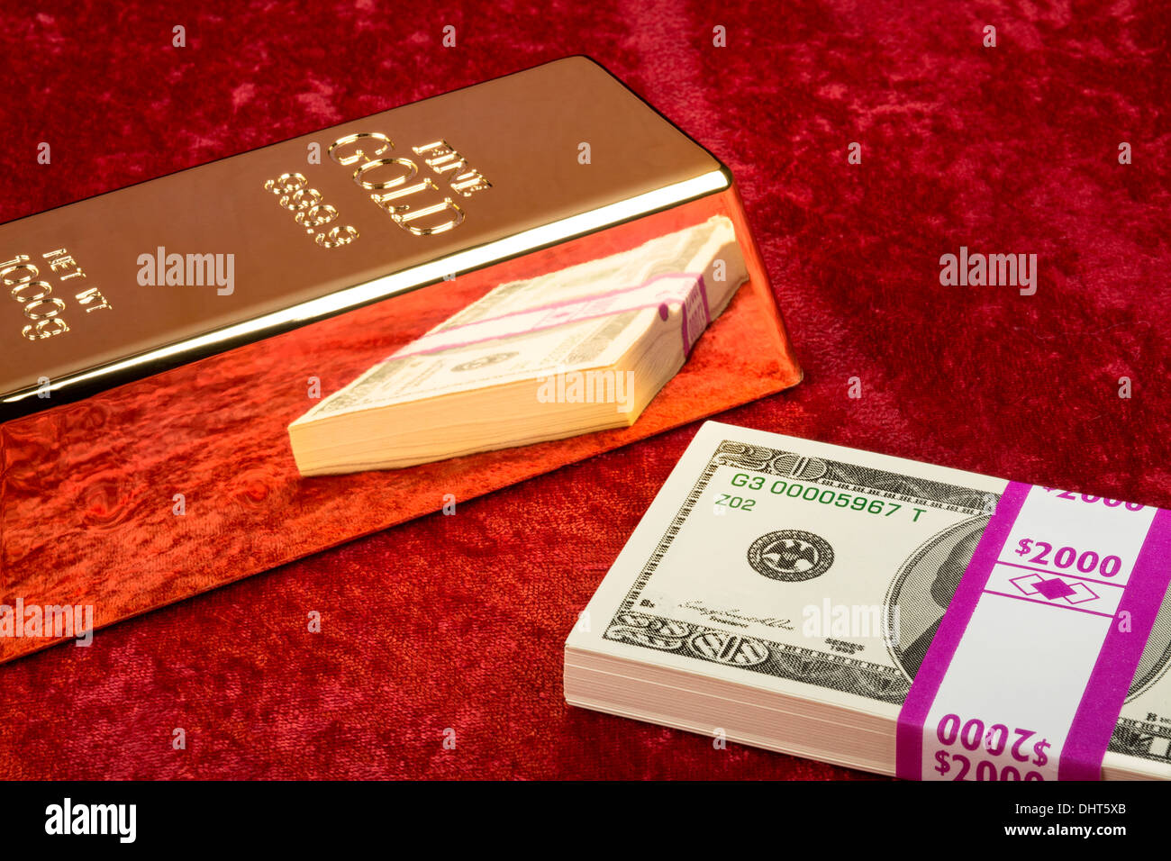 Une barre d'or avec une pile de caisse américaine sur velours rouge Banque D'Images