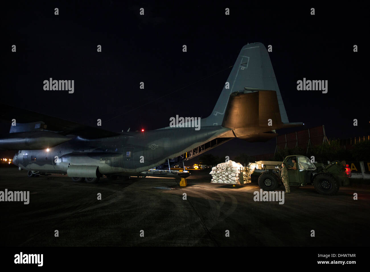 Manille, Philippines - U.S. Marines du bataillon logistique de combat 4, jointe à la 3D Marine Expeditionary Brigade (BAM), charger une palette de produits alimentaires dans une armée de l'air MC-130 au cours d'une nuit d'approvisionnement à typhoon-hit Tacloban dans le cadre d'Élève Banque D'Images