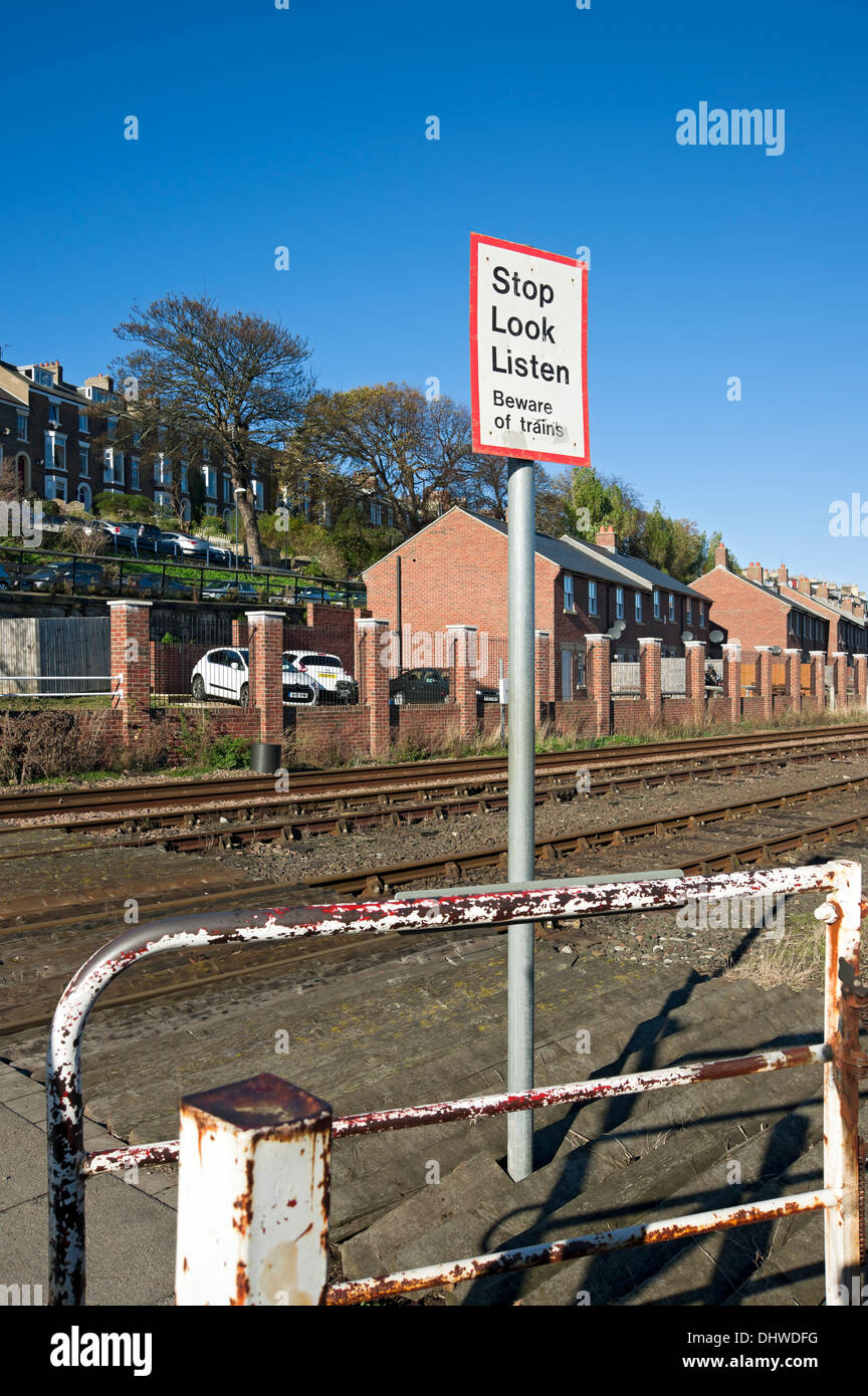 Arrêtez de regarder et écoutez le panneau d'avertissement au passage sans pilote de train Whitby North Yorkshire England Royaume-Uni GB Grande-Bretagne Banque D'Images