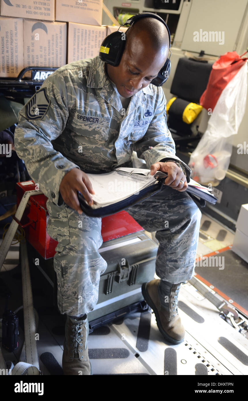 Le sergent-chef. Derontae Spencer, 734e Escadron de la mobilité aérienne, surintendant de production critiques la libération de paperasse qui va permettre à l'aéronef d'écarter le 15 novembre 2013, sur l'Andersen Air Force Base, Guam, flightline pour appuyer l'opération en Taclo Damayan Banque D'Images