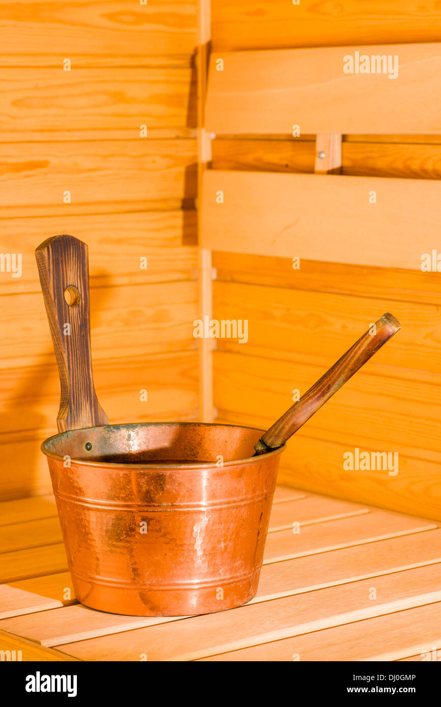 Seau de cuivre et le balancier dans un sauna finlandais, format vertical Banque D'Images