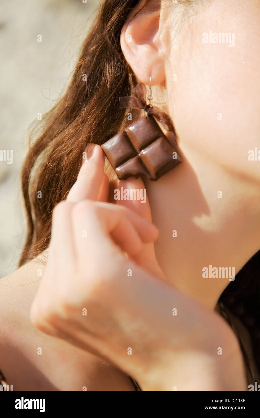 Earring en forme de chocolat dans l'oreille Banque D'Images